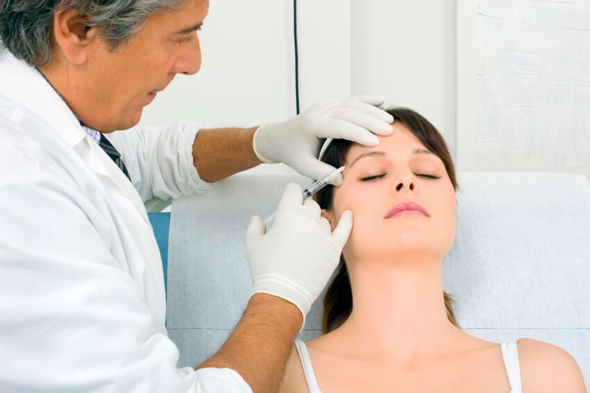 Doctor Performing Botox Treatment To Patient
