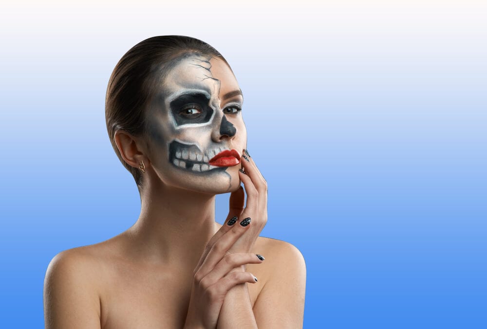 Woman with half face skeleton paint
