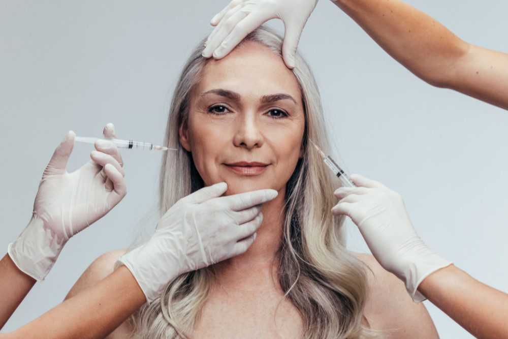 A woman receiving multiple units of Botox around different areas of her face.