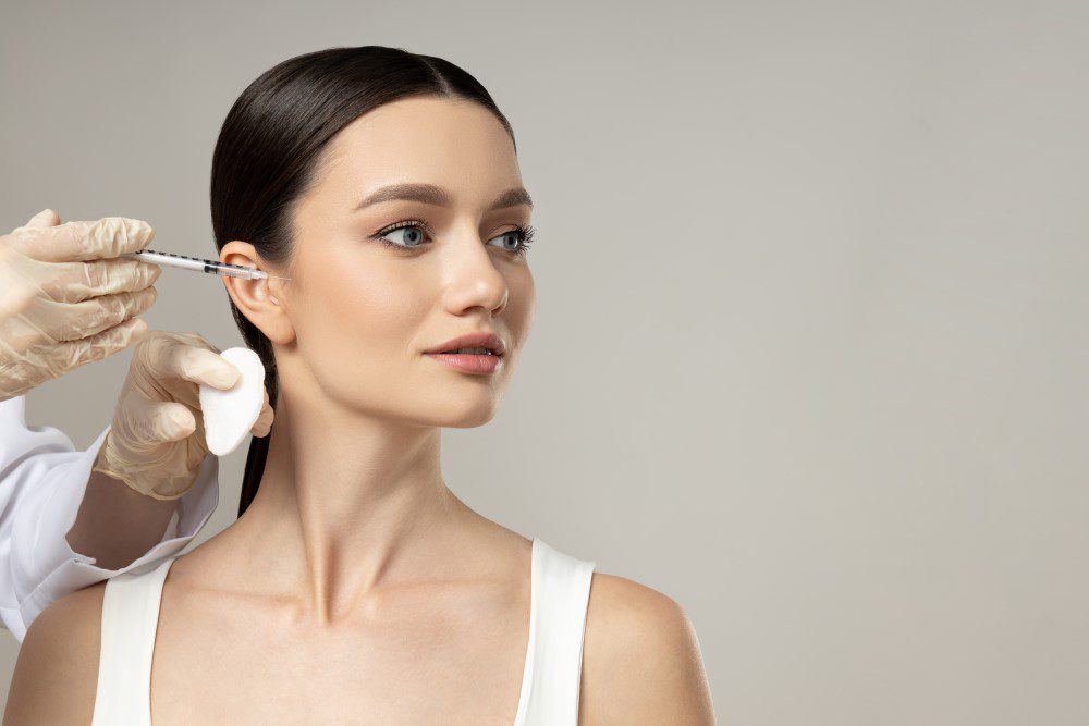 Woman receiving Botox injections from a specialist.