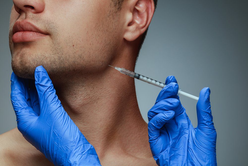 A man receiving Botox near the jawline by a clinician.