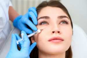 doctor at Your Laser Skin Care giving woman under eye filler in Los Angeles