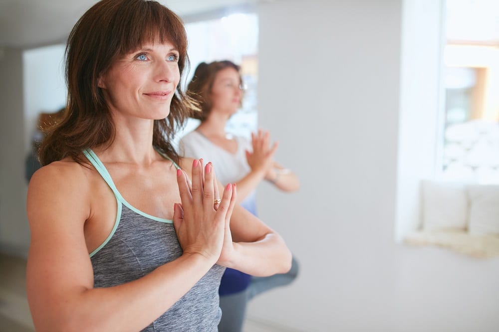 Women performing yoga exercise